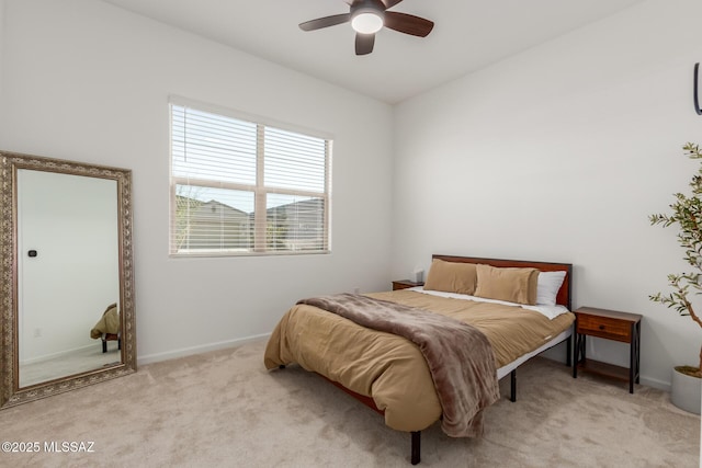 bedroom with ceiling fan and light colored carpet