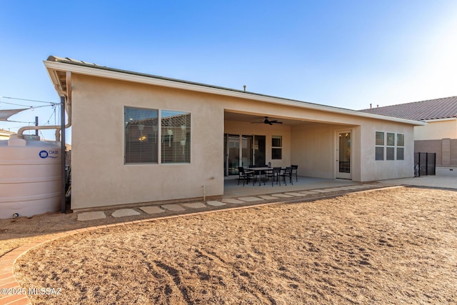 back of property with a patio area and ceiling fan