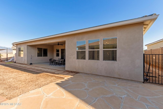 back of property featuring a patio area and ceiling fan