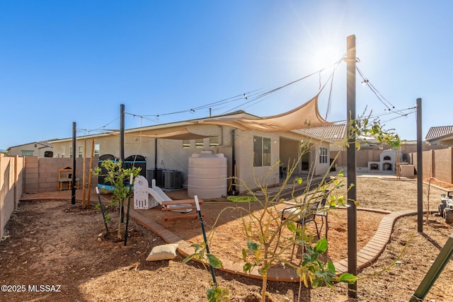 rear view of property featuring central AC unit and a patio area