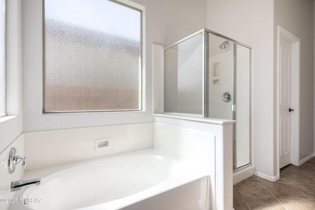 bathroom featuring tile patterned floors and separate shower and tub