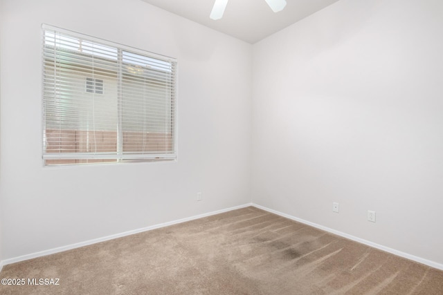 carpeted empty room featuring ceiling fan