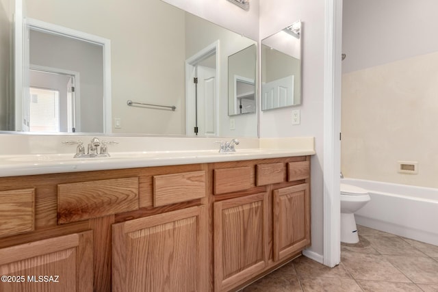 full bathroom featuring vanity, tile patterned floors, toilet, and bathtub / shower combination