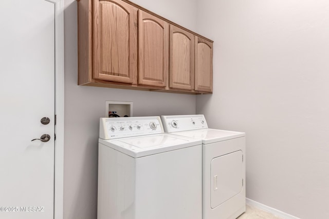 washroom with cabinets and separate washer and dryer