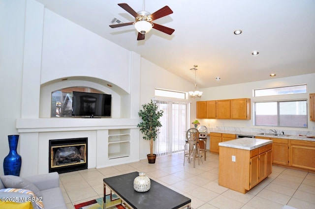 kitchen featuring hanging light fixtures, plenty of natural light, a center island, and sink