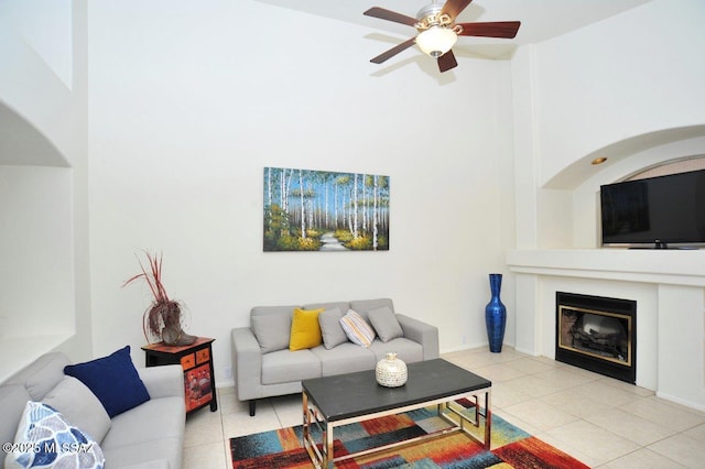 tiled living room featuring ceiling fan