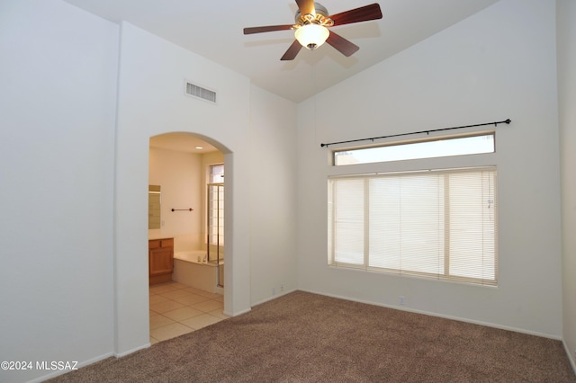 unfurnished room featuring ceiling fan, light colored carpet, and high vaulted ceiling