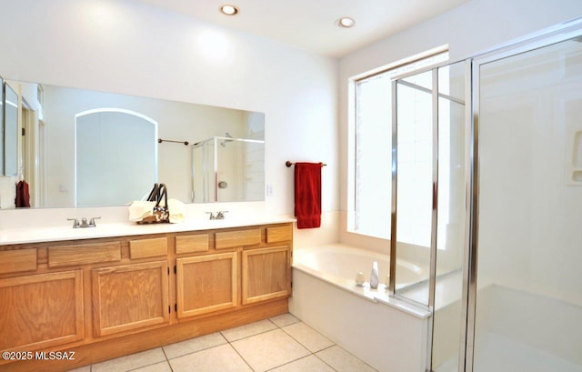 bathroom featuring independent shower and bath, vanity, plenty of natural light, and tile patterned flooring