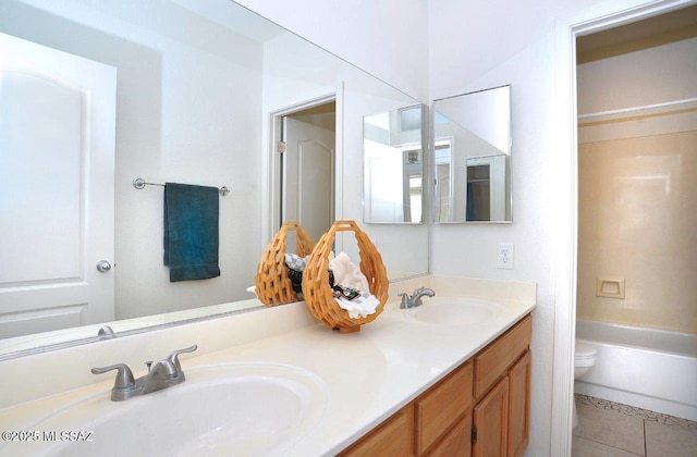 bathroom with tile patterned floors, toilet, and vanity