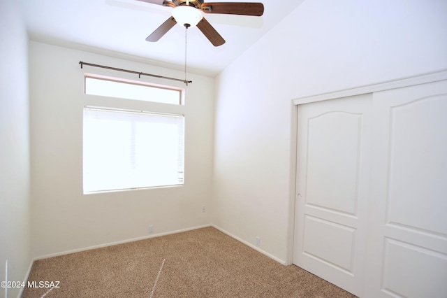 unfurnished bedroom with ceiling fan, carpet flooring, vaulted ceiling, and a closet