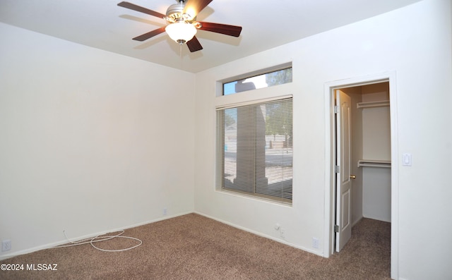 carpeted spare room with ceiling fan