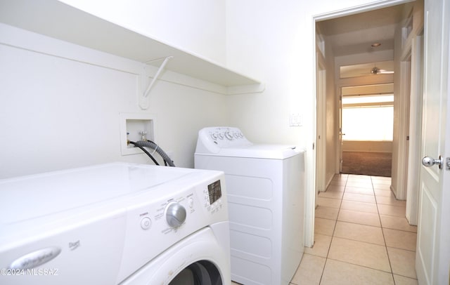 laundry room featuring light tile patterned floors and washer and dryer