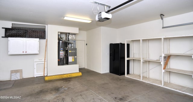 garage with a garage door opener, washer / dryer, heating unit, and black fridge