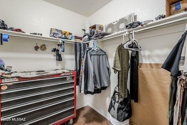 spacious closet featuring dark tile patterned floors