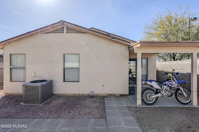 view of home's exterior with a carport and central air condition unit