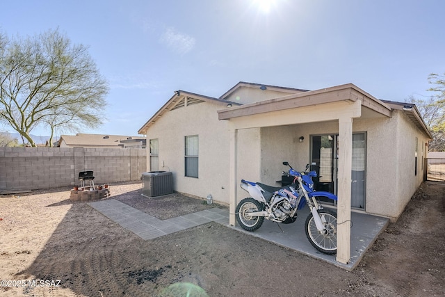 back of property with a patio and central AC