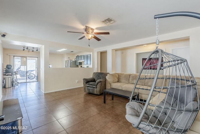 tiled living room with ceiling fan