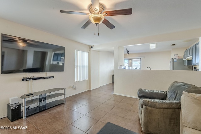 living room with light tile patterned floors and ceiling fan