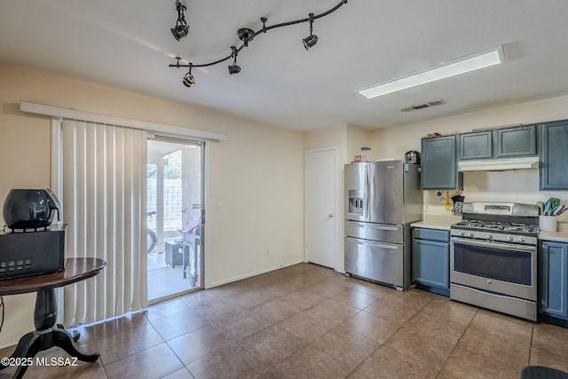 kitchen featuring stainless steel appliances and light tile patterned flooring