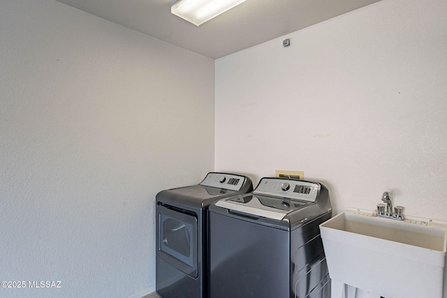 laundry area with sink and washer and clothes dryer