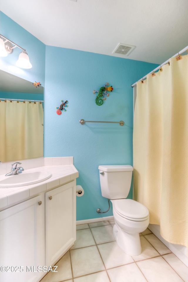 bathroom with tile patterned floors, toilet, and vanity