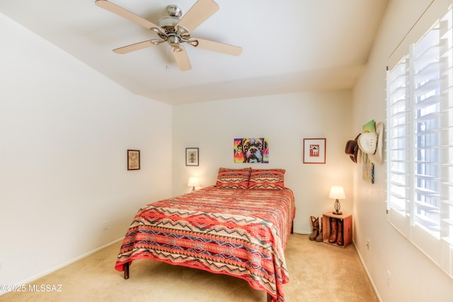 bedroom with ceiling fan and light carpet