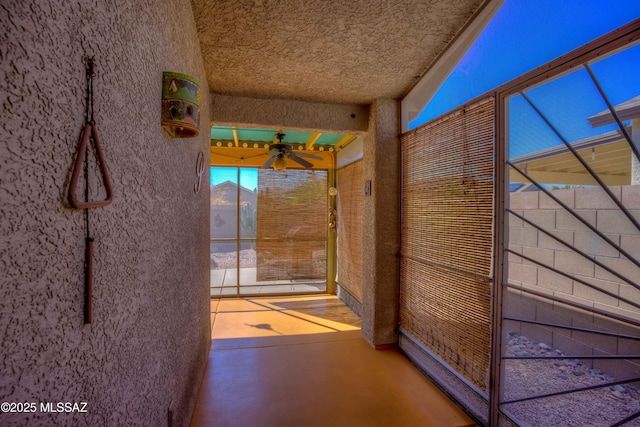 doorway to outside with concrete floors and ceiling fan