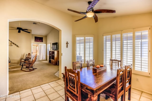 dining area featuring ceiling fan and light carpet