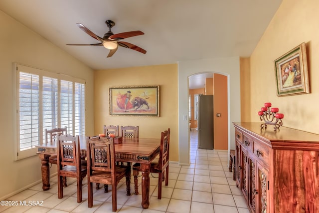 tiled dining area with vaulted ceiling and ceiling fan