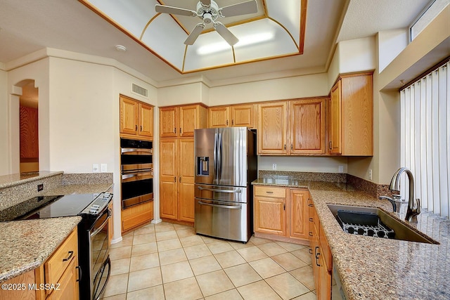 14686 N Lost Arrow Dr, Oro Valley, AZ 85755 - kitchen with stainless steel appliances, light tile patterned flooring, sink, and stone counters