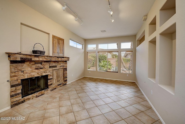 14686 N Lost Arrow Dr, Oro Valley, AZ 85755 - unfurnished living room featuring a fireplace and light tile patterned floors