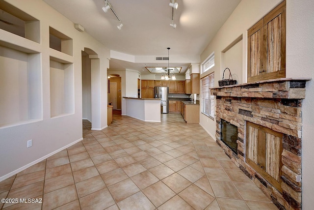 14686 N Lost Arrow Dr, Oro Valley, AZ 85755 - kitchen featuring pendant lighting, light tile patterned flooring, stainless steel fridge with ice dispenser, a stone fireplace, and a chandelier