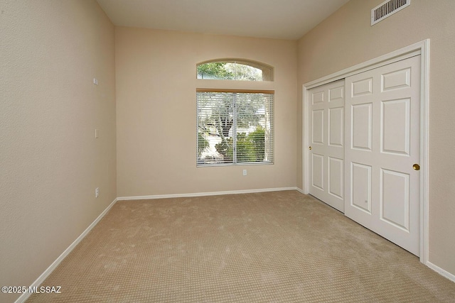 14686 N Lost Arrow Dr, Oro Valley, AZ 85755 - unfurnished bedroom featuring light carpet and a closet