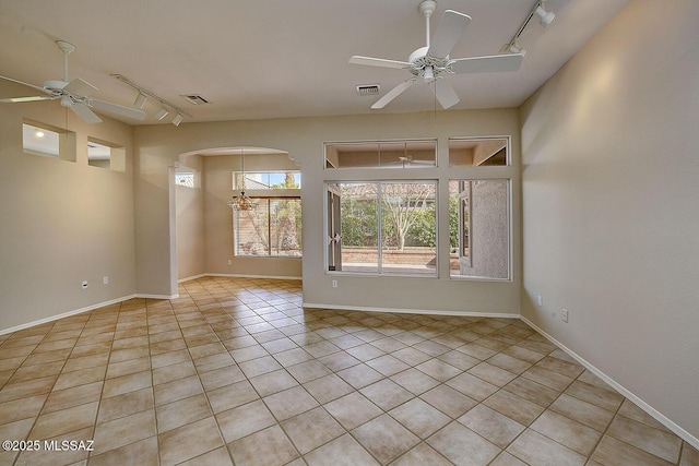 14686 N Lost Arrow Dr, Oro Valley, AZ 85755 - empty room with light tile patterned flooring, rail lighting, and ceiling fan with notable chandelier