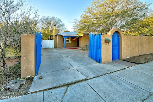 exterior space with a fenced front yard and a gate