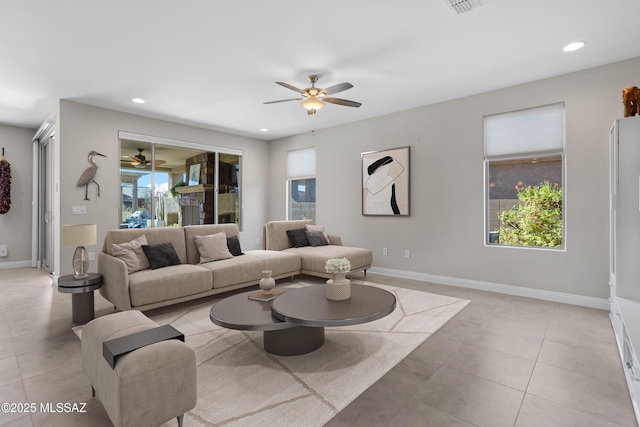 living room with plenty of natural light, recessed lighting, and baseboards