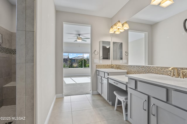 bathroom featuring a sink, backsplash, double vanity, and tile patterned flooring