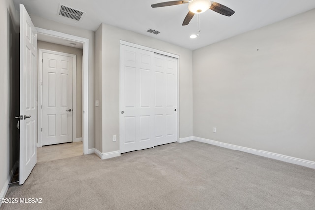 unfurnished bedroom featuring baseboards, visible vents, a closet, and light carpet