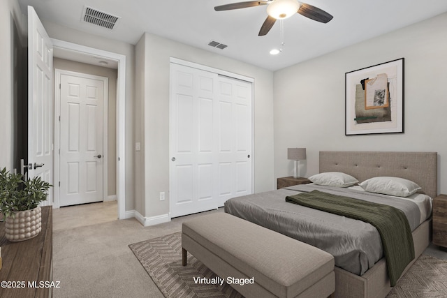 bedroom featuring baseboards, visible vents, a closet, and light colored carpet