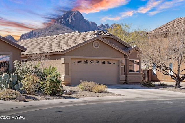 view of front of property with a garage and a mountain view