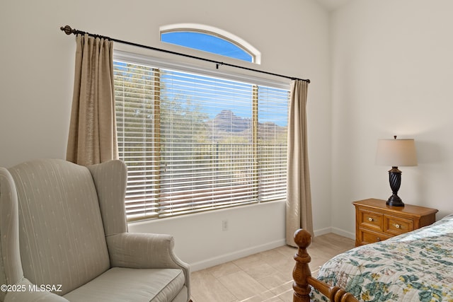 bedroom with multiple windows and light tile patterned floors