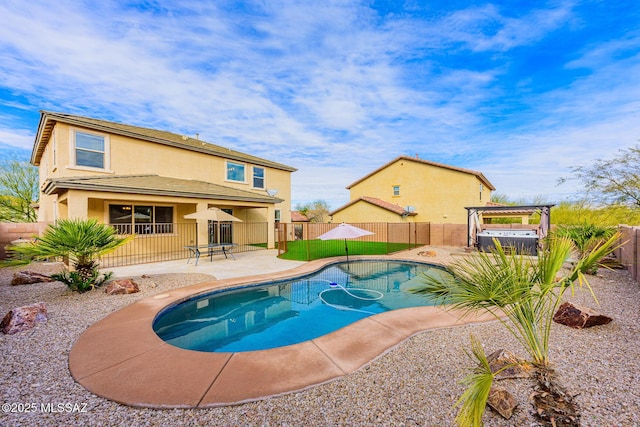 view of swimming pool featuring a patio area and a hot tub