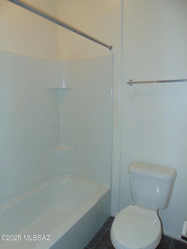 bathroom featuring tub / shower combination, tile patterned flooring, and toilet