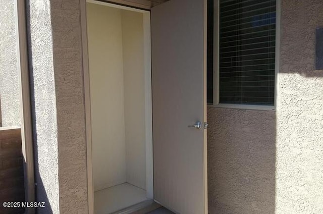 view of exterior entry with stucco siding