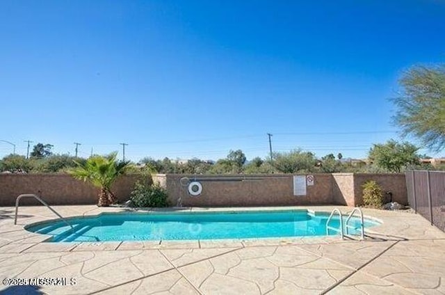 view of pool with a patio area, fence, and a fenced in pool