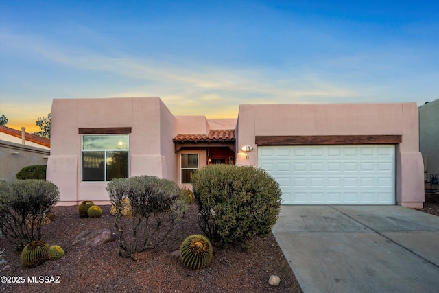 southwest-style home featuring a garage