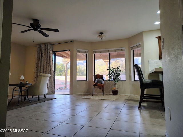 interior space with light tile patterned flooring, plenty of natural light, and baseboards