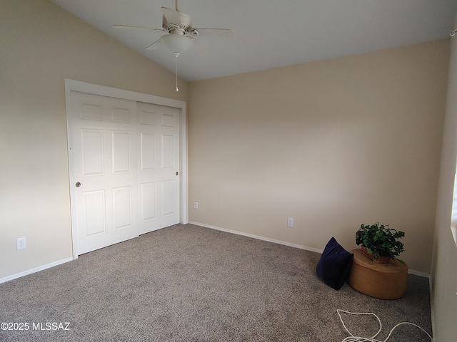 unfurnished bedroom featuring vaulted ceiling, carpet floors, ceiling fan, and baseboards