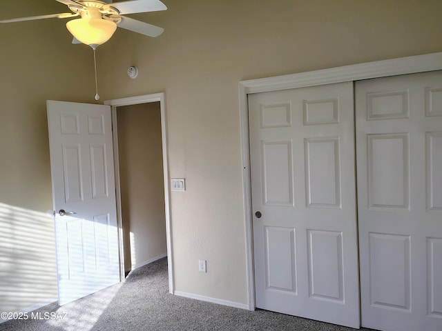 unfurnished bedroom featuring carpet floors, baseboards, and a closet