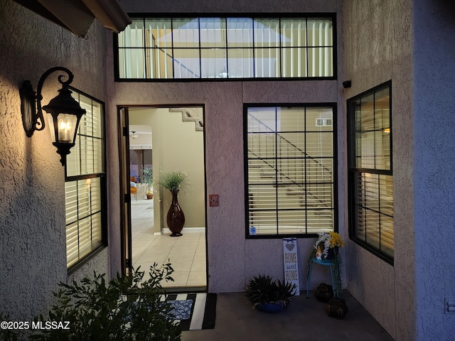 exterior space with a wealth of natural light and a textured wall